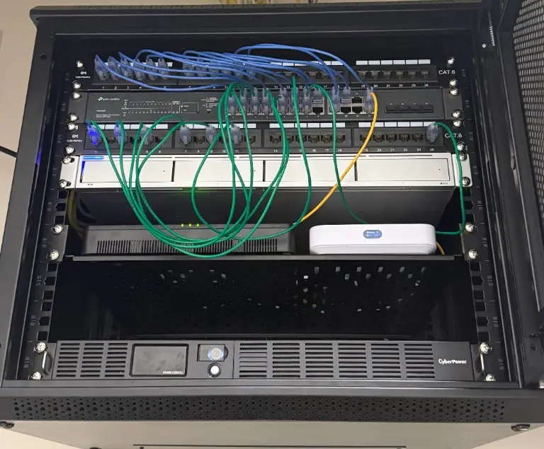 Configured black network rack cabinet showing switches and patch panels